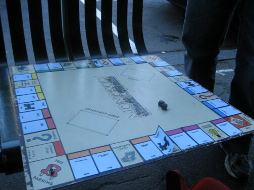 View of a Monopoly board on a street bench.